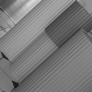 a close up of the fluted base legs in black and white