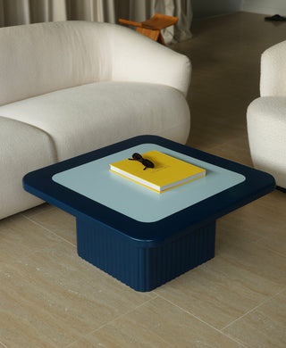 Modern coffee table with a yellow book on it in a living room setting